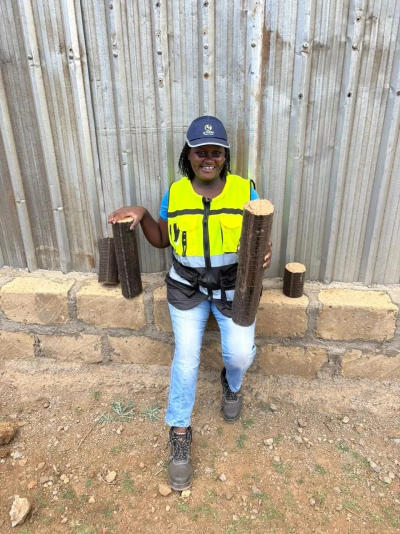 Esther Njeri, Co-Founder & CEO, holding Super Logs at the Utheri yard